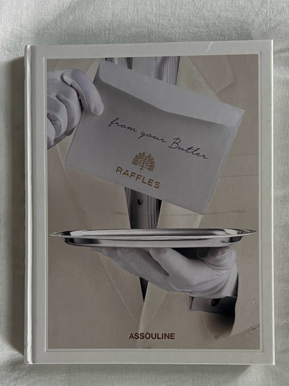 Assouline book with white, cream and silver cover art